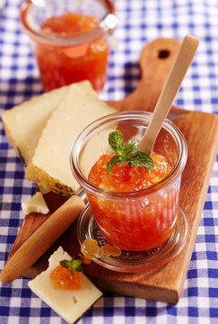 Homemade pineapple and fig jam in a preserving jar with hard cheese