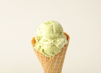 Delicious ice cream in waffle cone on white background, closeup