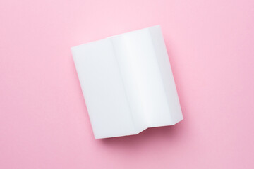 Melamine sponges on pink background, minimalism , white figure, kitchen and home cleaning