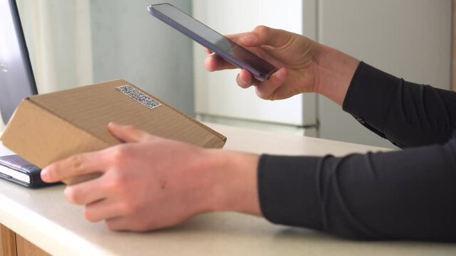 Attaching a QR code to delivery or package. QR code scanning app. Touchless digital payment option for businesses