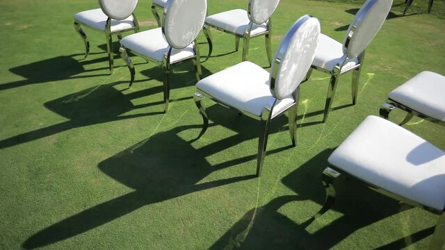 White chairs in the yard at the wedding ceremony