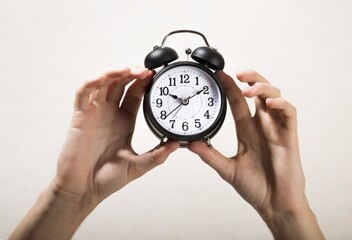 Hands Holding an Alarm Clock