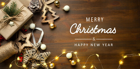 art Christmas banner, Xmas sparkling lights garland with gifts box and wooden tinsel. Christmas greetings cards, headers, website. © Konstiantyn