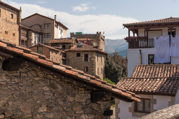 Ancient stone-made buildings with tiled roofs in Potes, Cantabria, Spain