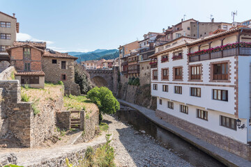 Fototapeta premium Traditional buildings made of stone on a sunny day in Potes, Cantabria, Spain