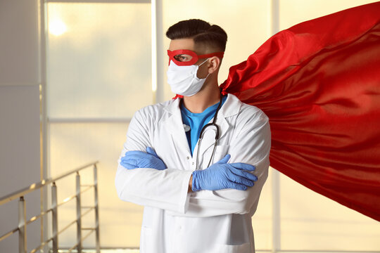 Doctor wearing face mask and cape indoors. Super hero power for medicine