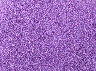 Glittering purple sand pile, Christmas and holiday decoration background and texture