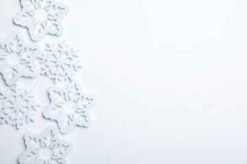 Beautiful decorative snowflakes on white background, flat lay. Space for text