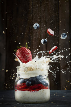 Muesli with yoghurt splash and berries in glass