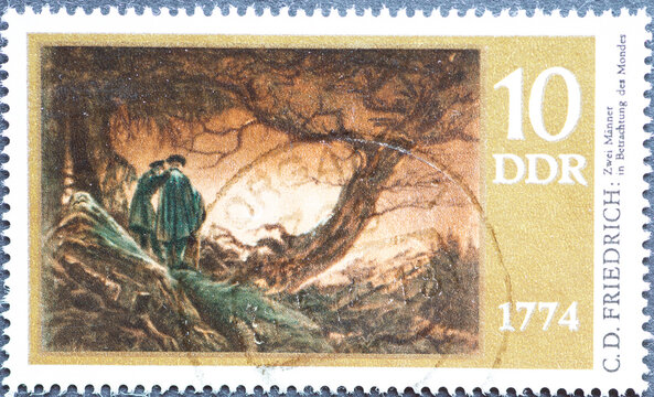 GERMANY, DDR - CIRCA 1974 : a postage stamp from Germany, GDR showing Two men contemplating the moon. 200th birthday of Caspar David Friedrich