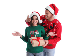 Man presenting Christmas gift to his girlfriend on white background