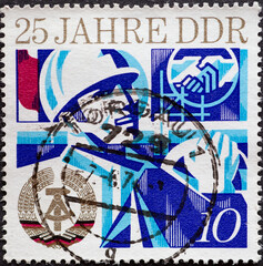 GERMANY, DDR - CIRCA 1974 : a postage stamp from Germany, GDR showing Motives from social life. 25 years of the GDR