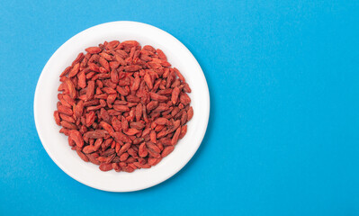 dried goji berries on a white plate