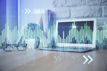 Financial graph colorful drawing and table with computer on background. Double exposure. Concept of...
