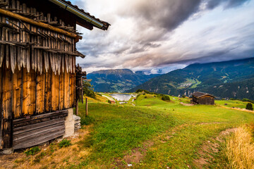 A great view over the Austrian Alps with a wooden house in the foreground.