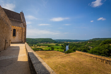 Great views over the Dordogne river in the distance, a bridge and woods.