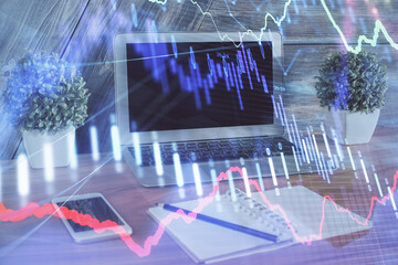 Financial market graph hologram and personal computer on background. Multi exposure. Concept of forex.