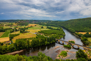 Great views over the Dordogne river in the distance, a bridge and woods.