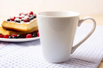 Obraz na płótnie Canvas White coffee latte mug mockup with waffles and berries