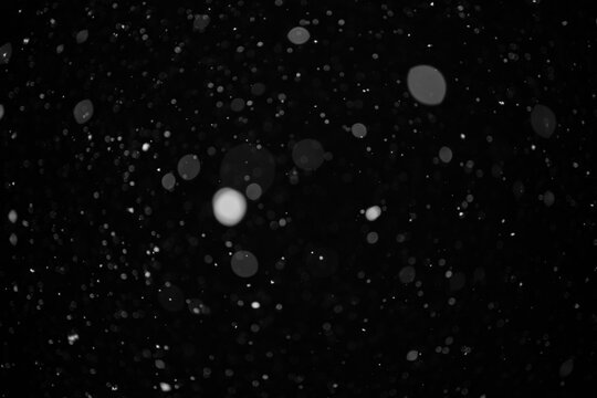 Abstract Background Defocus Light Spots on a black background.