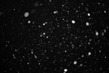 Fototapeta na wymiar snow bokeh texture on black background