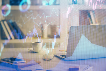 Financial graph colorful drawing and table with computer on background. Double exposure. Concept of...