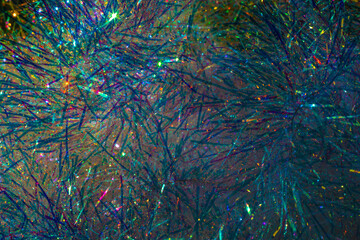 Multicolored glowing tinsel, sparkling christmas decoration, christmas background