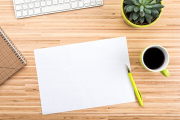 Wooden desk with computer keyboard, coffee cup, potted succulent plant, stationery and copy space...