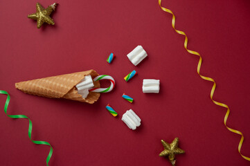 new year card: waffle cone with marshmallows, candy and Christmas toys