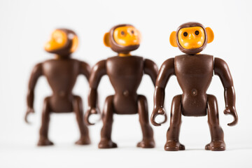 Obraz premium Three toy monkeys distanced from each other