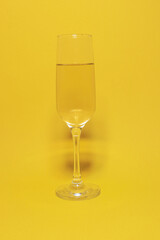 
Christmas background with glasses of champagne and Christmas decor on a yellow background