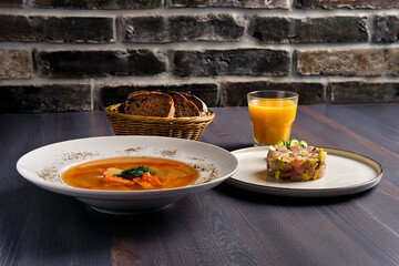 Traditional lunch with salmon soup and herring tartar