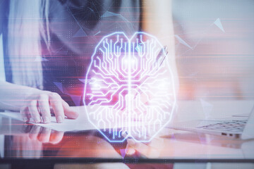 Multi exposure of woman's writing hand on background with brain hud. Concept of learning.