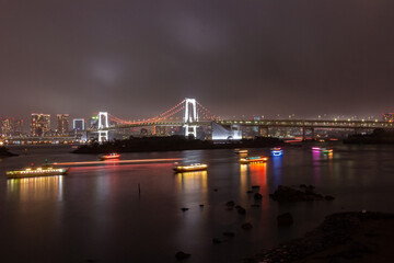 Rainbow bridge at night in Daiba district in Tokyo (Japan)