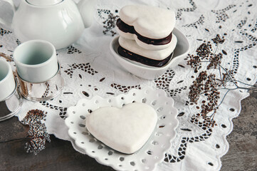 gingerbread hearts in white icing and chocolate on a beautiful white napkin. Traditional Christmas gingerbread cookies
