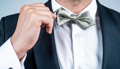 Elegant silver colored bowtie worn with tuxedo formal fashion style, elegance