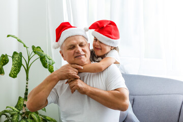 Obraz premium Happy childhood. Child enjoy christmas with Santa claus. Granddaughter spend time with grandpa. Christmas eve. Family.