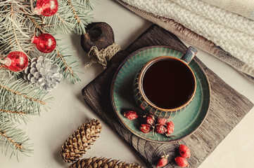 Cup of tea or coffee with a kettle for Christmas. Christmas still life. Warming winter tea with vitamins from rosehip. top view