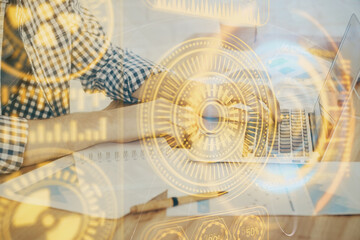Technology theme hologram with man working on computer on background. High tech concept. Double exposure.