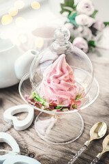 fresh handmade marshmallows in a light mood. Close-up of a pink marshmallow in a transparent glass vase. Serving handmade confectionery in a cafe
