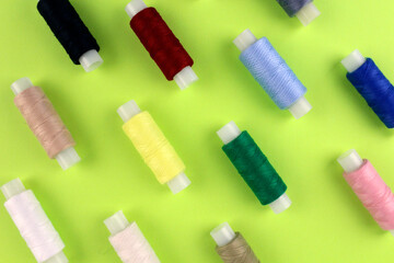 Multicolored threads on a light green background