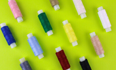 Multicolored threads on a light green background