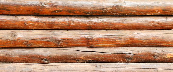 wall made of wooden logs background. wooden beams fence texture