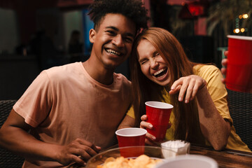 Group of young friends drinking and laughing