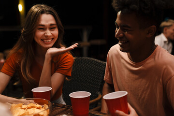 Group of young friends drinking and laughing
