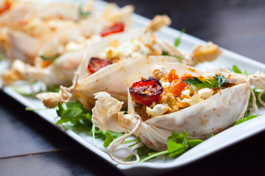 Pergament nests with tomatoes and cheese