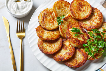 Fototapeta na wymiar Potato pancakes on a light marble background