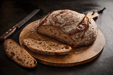 Sour dough bread sliced on a chopping bread
