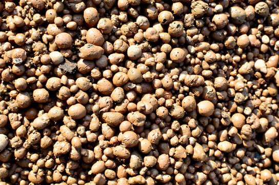Expanded clay background. Hydro crunch expanded clay hydroton is available in the form of crushed stone or gravel. Artificial porous aggregate for light concrete, widely used in modern construction
