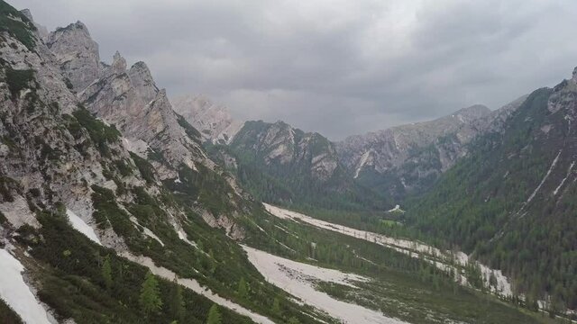 Aerial view of Alpine mountains with forest and mudflow